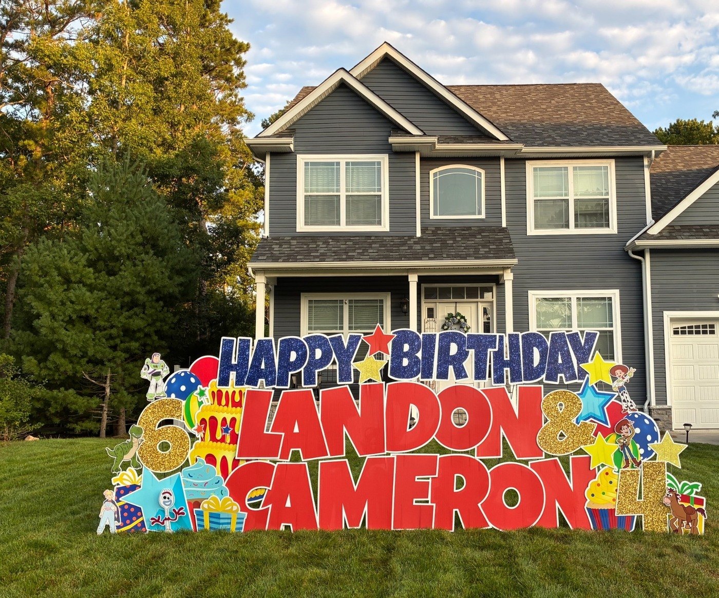 Happy Birthday Landon and Cameron Toy Story yard card display with Buzz Lightyear, Jessie, Forky, balloons, and a birthday cake